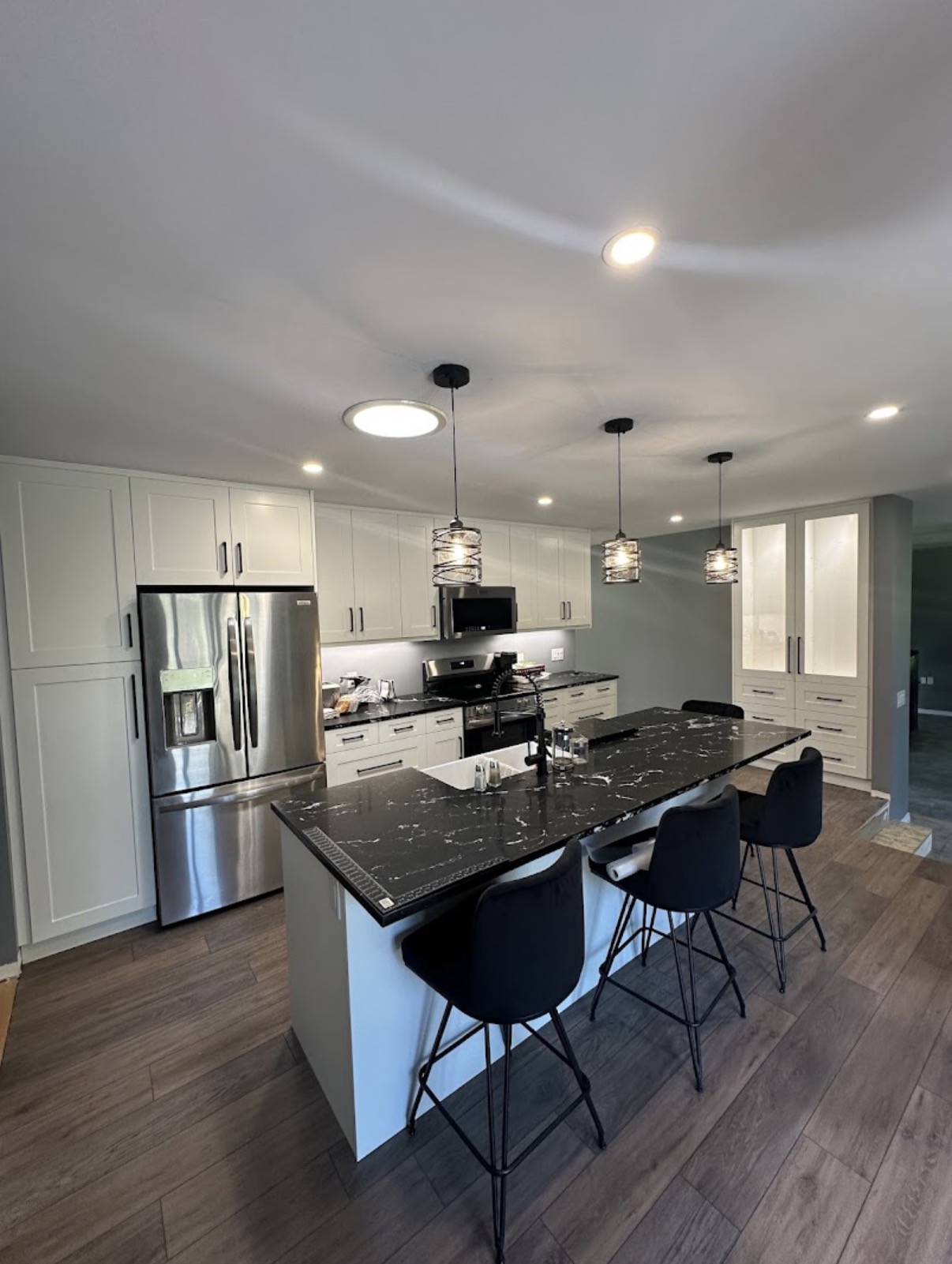 Completed kitchen renovation with coordinated electrical lighting and appliances